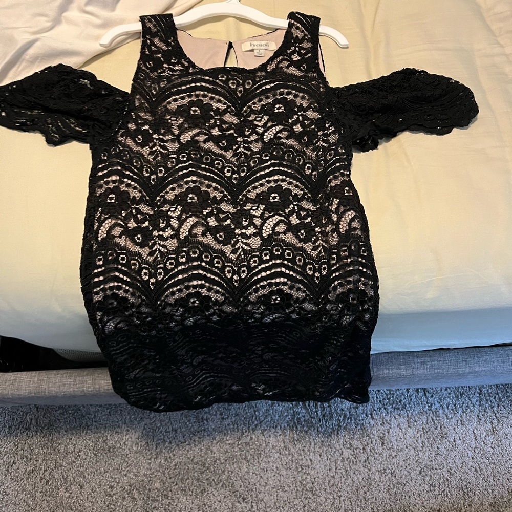 Black mini dress with nude underlay.